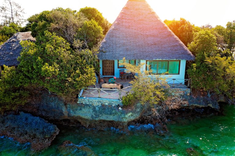 Thatched villa perched on the coral rock at The Island Pongwe