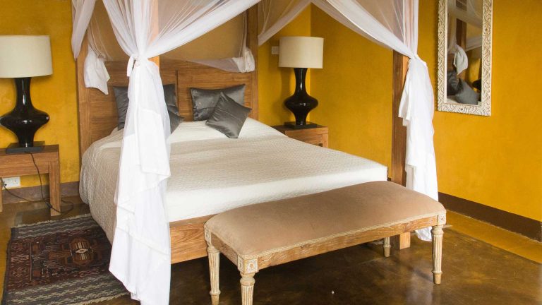 French Prestige suite with a canopied bed and turmeric-yellow walls at Kholle House