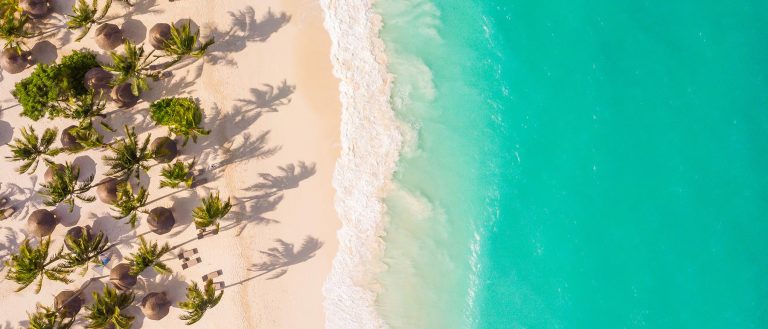 Overhead view of white sand and turquoise sea at Zuri Zanzibar