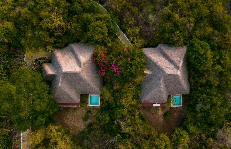 Aerial view of thatched villas with plunge pools at Konokono