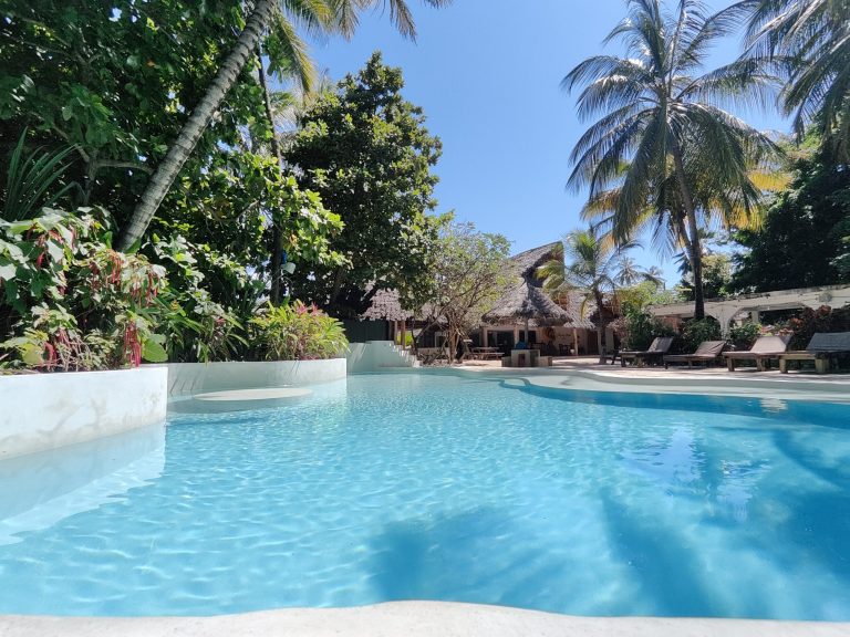 Pool with sunbeds in a tropical garden at Paje by Night