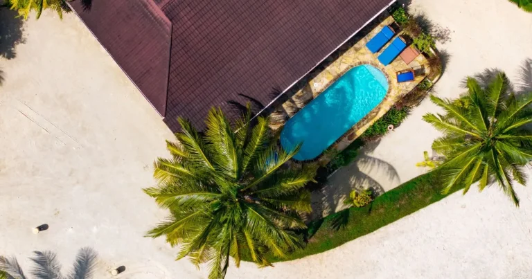 Overhead view of a pool bungalow's private pool among palms at Kendwa Rocks