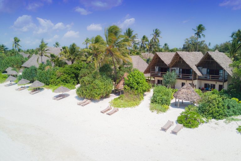 Beachfront suite bungalows among palms at Zanzibar Pearl