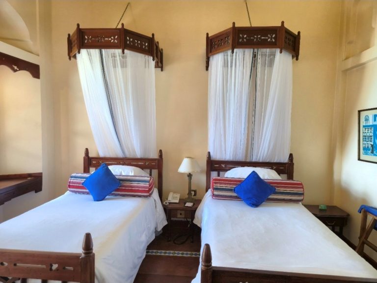 Standard Twin Room with two canopied single beds at Zanzibar Serena Hotel