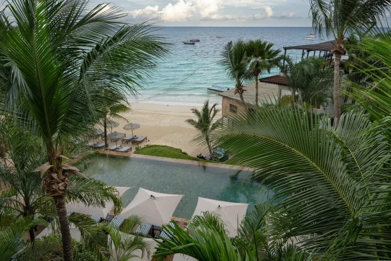 View over The Z Hotel infinity pool and palms to Nungwi beach
