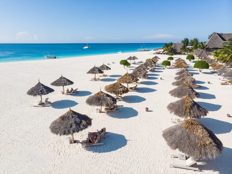 Thatched umbrellas and loungers on Gold Zanzibar's white-sand beach