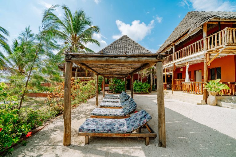 Thatched shade and loungers outside the bungalows at Shanuo