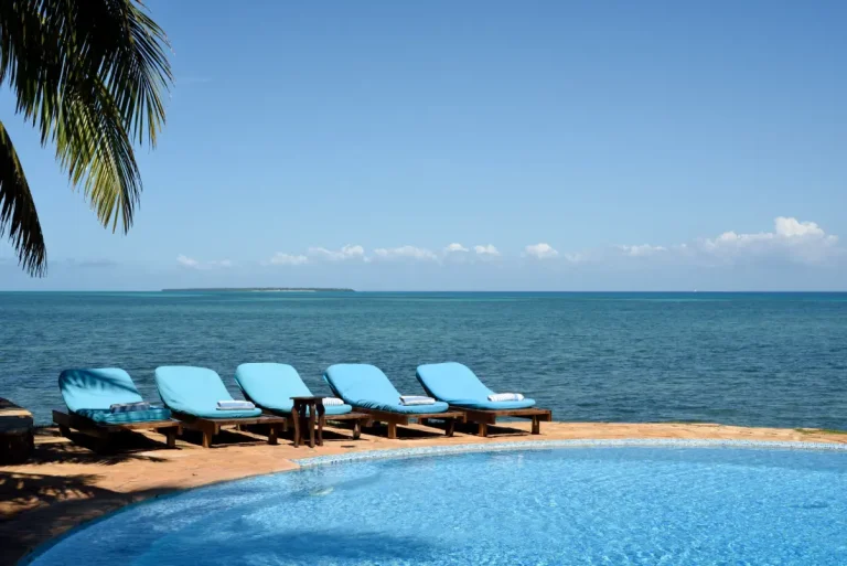 Pool with blue loungers overlooking the sea at Fumba Beach Lodge