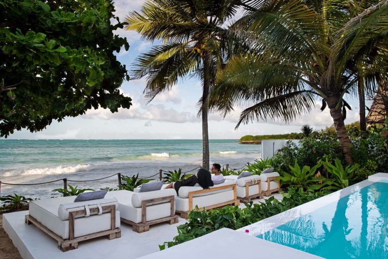 Daybeds beside the pool facing the ocean at Upendo Beach