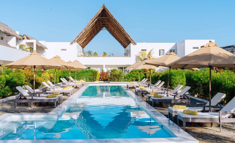 25-metre pool with sun loungers and umbrellas at Dhow Inn, Paje