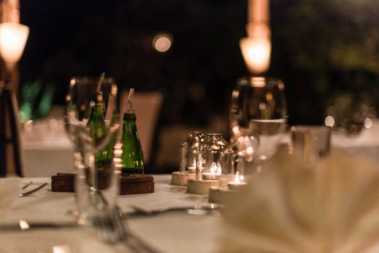 Candlelit table set for dinner in the garden at Villa Kiva