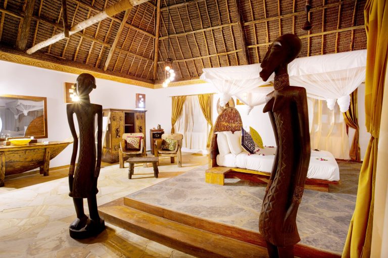 Sultan Villa with king bed, carved statues and Arabic-African furniture at The Island Pongwe