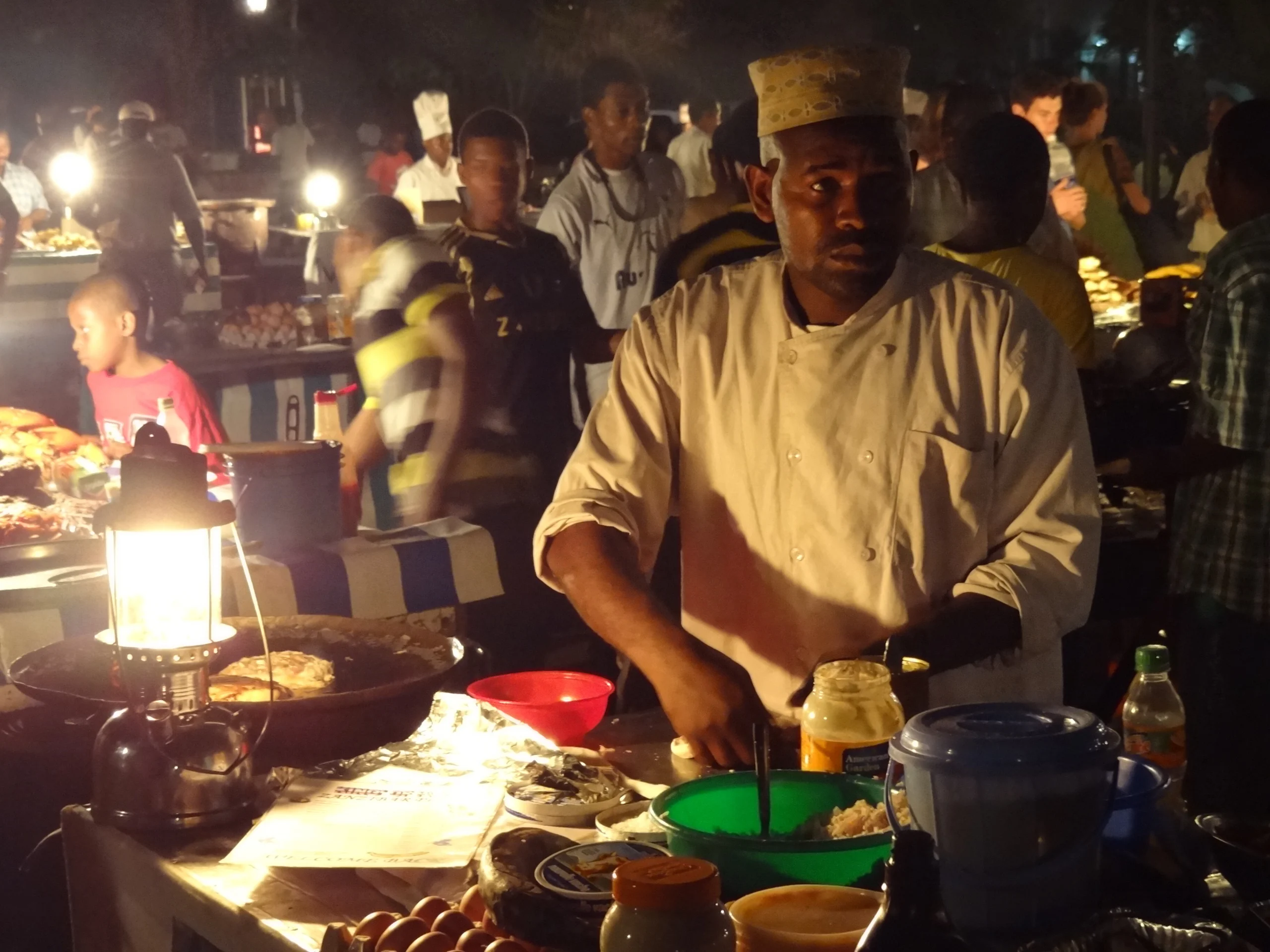 Food vendor grilling at the Forodhani Gardens night market, Stone Town