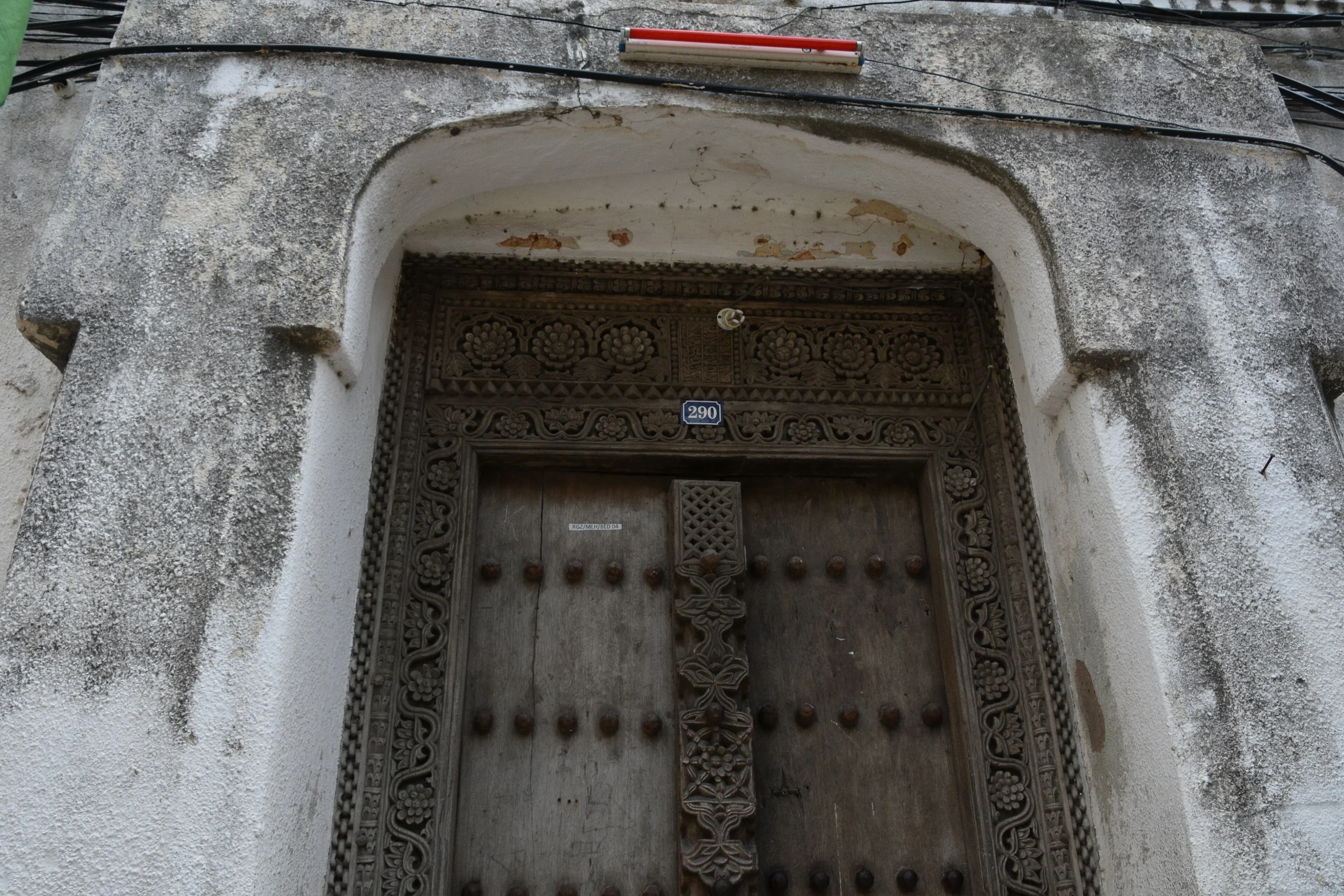 Carved wooden door with brass studs in Stone Town, Zanzibar